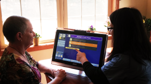 Caregiver showing grandCARE user new task list feature on the resident's touchscreen.
